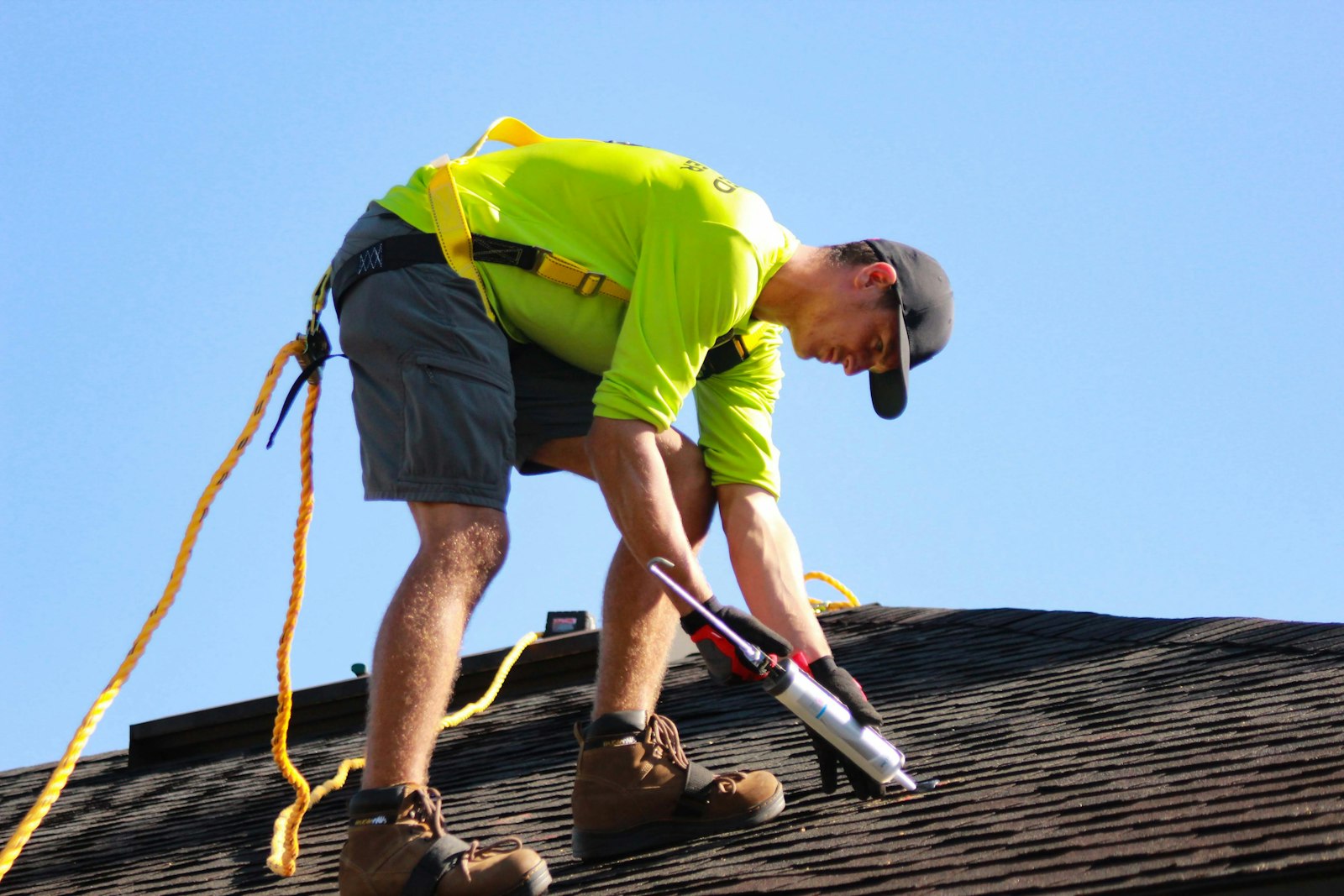 Emergency roof repair Huntington Beach — roofer in hi-vis gear