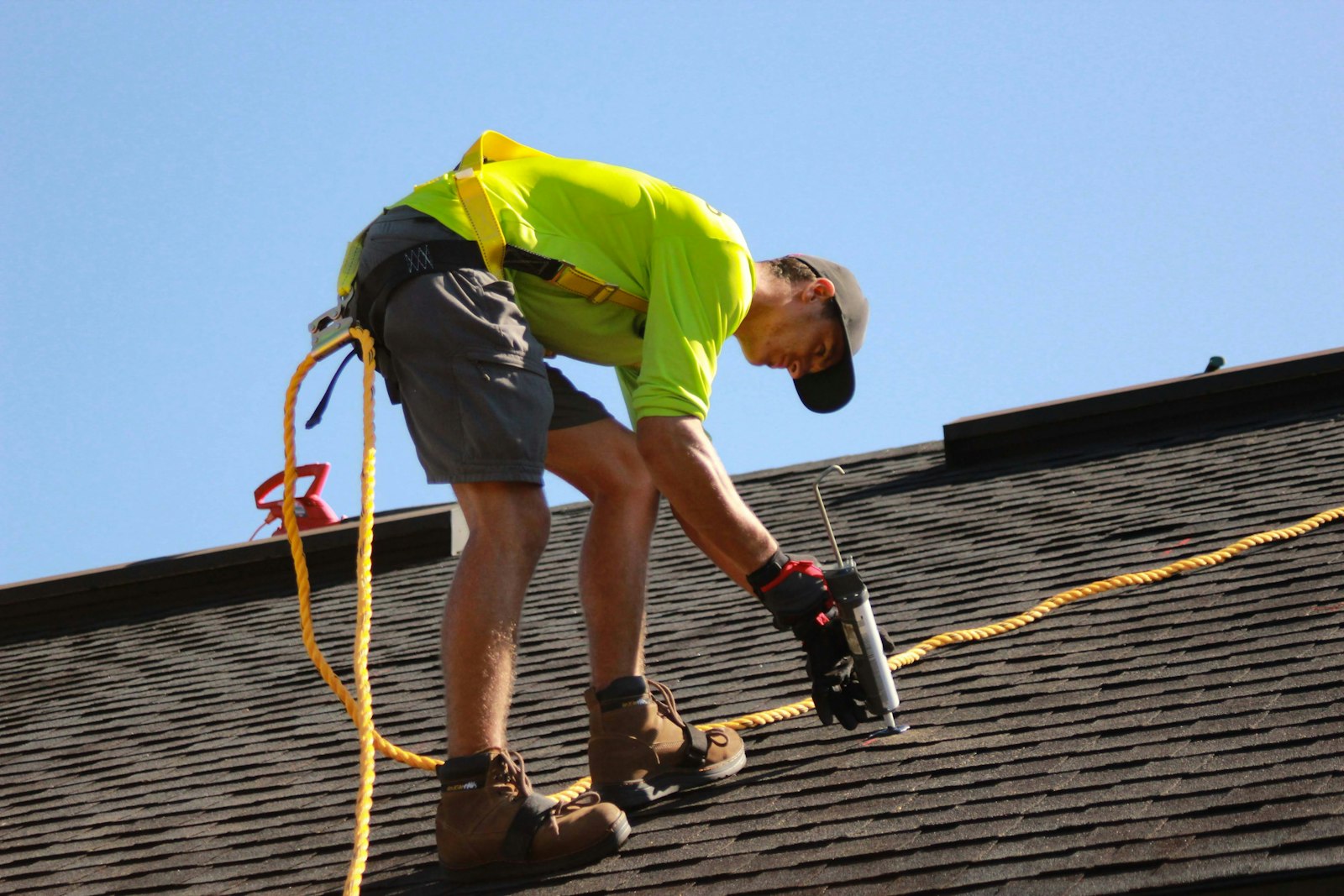 Emergency roof repair Huntington Beach technician with a power drill