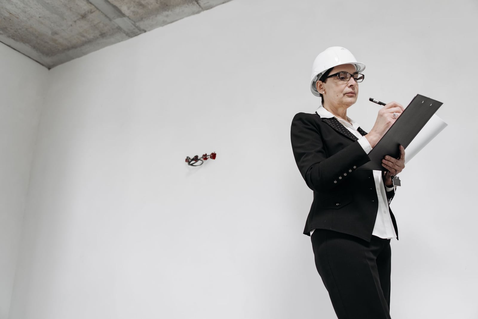 Taking notes during a final construction inspection