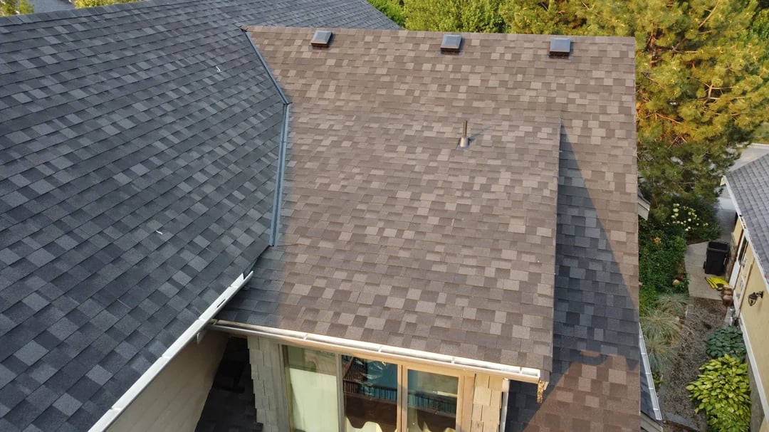 Shingle roof valley with roof vents and skylight nearby on a Huntington Beach home