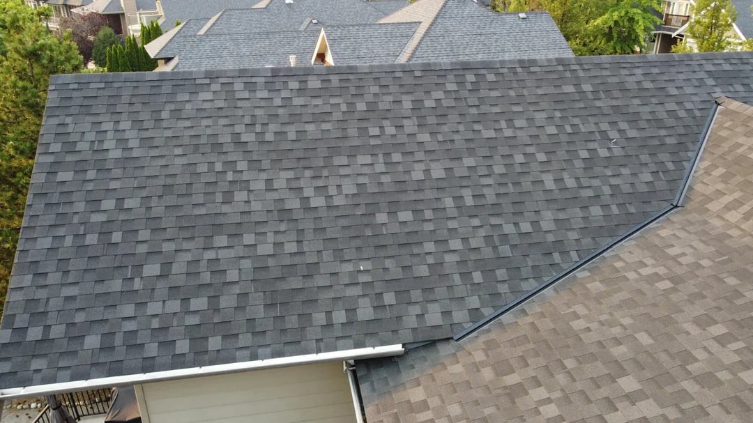 Roof valley with metal flashing between two shingle roof planes on a Huntington Beach home