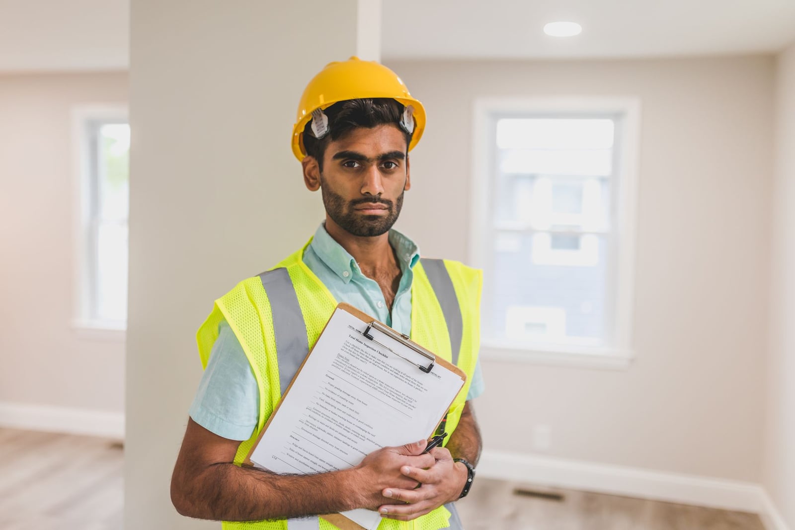 Inspector holding a clipboard during a home inspection
