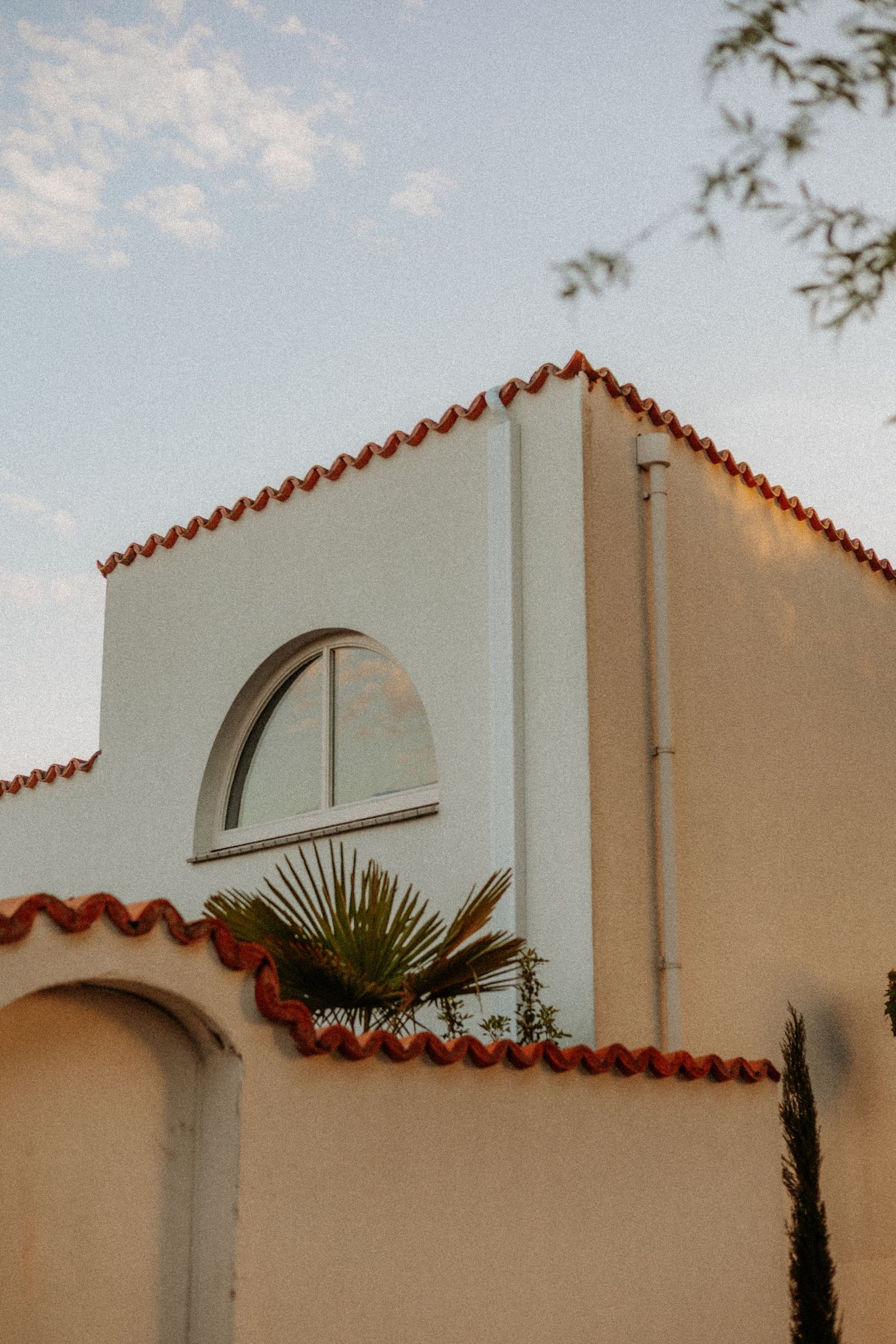 Mediterranean-style home with a red tile roof