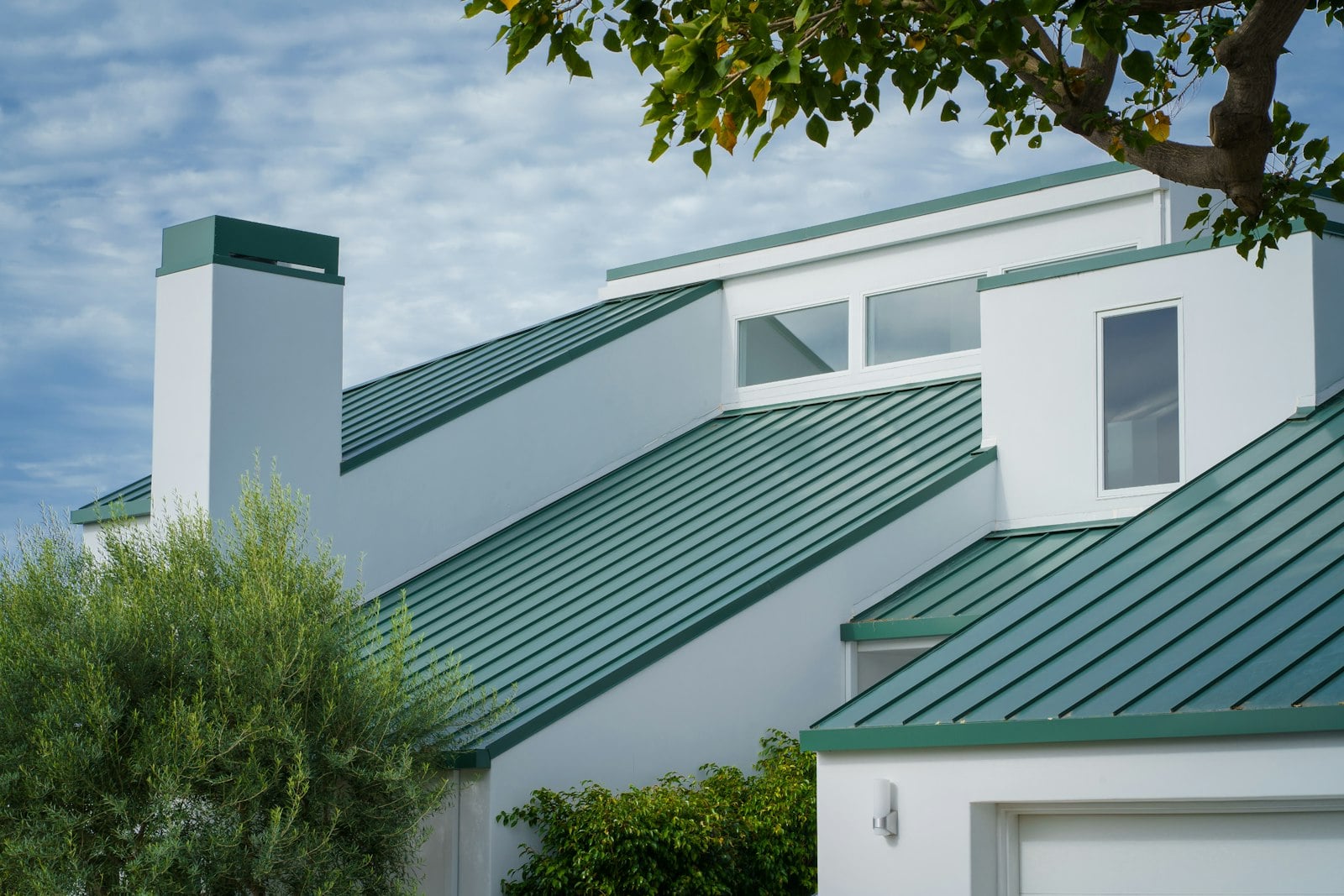 Metal roof with chimney flashing detail on a residential home