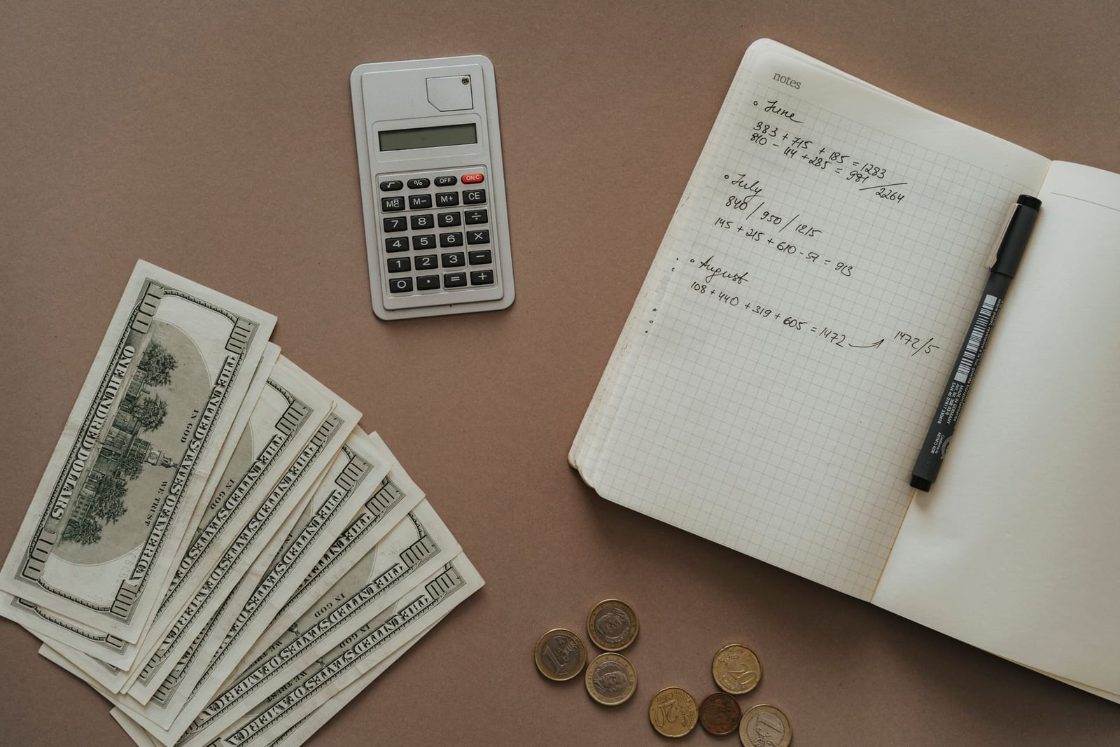 Notebook and money representing rebate savings calculations