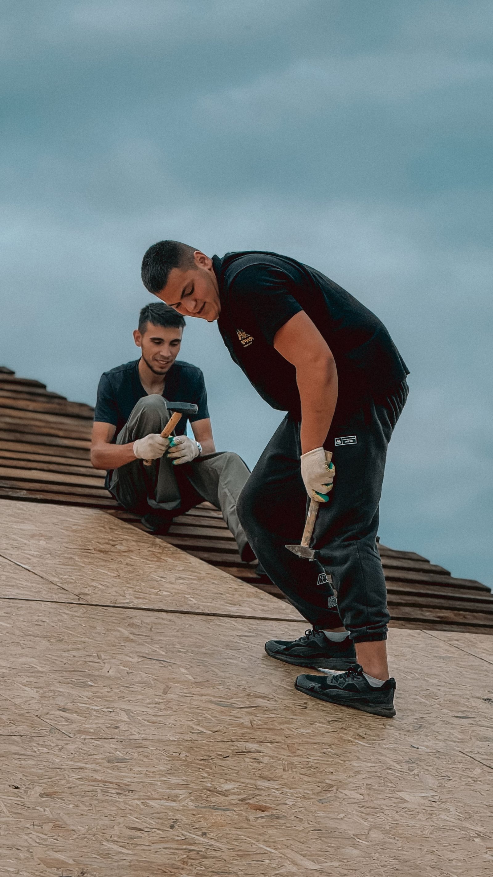 Roofing workers installing new roof decking
