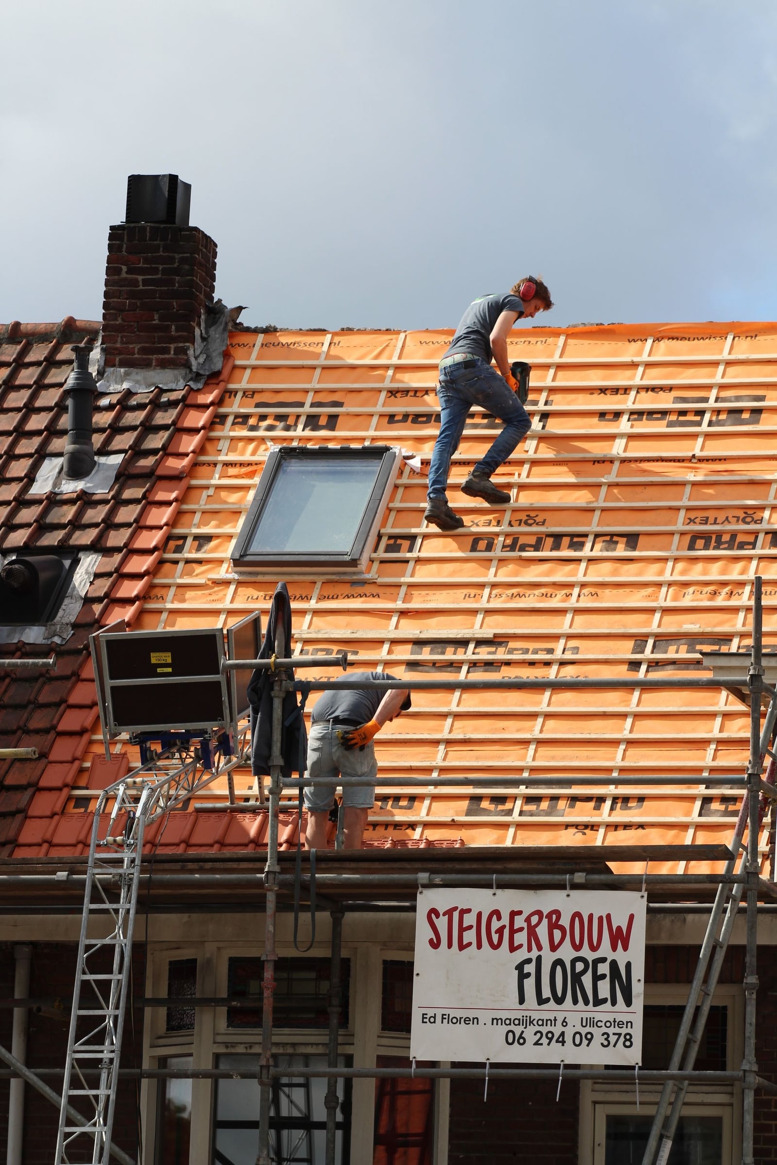 Roofer working on a roof during a skylight installation