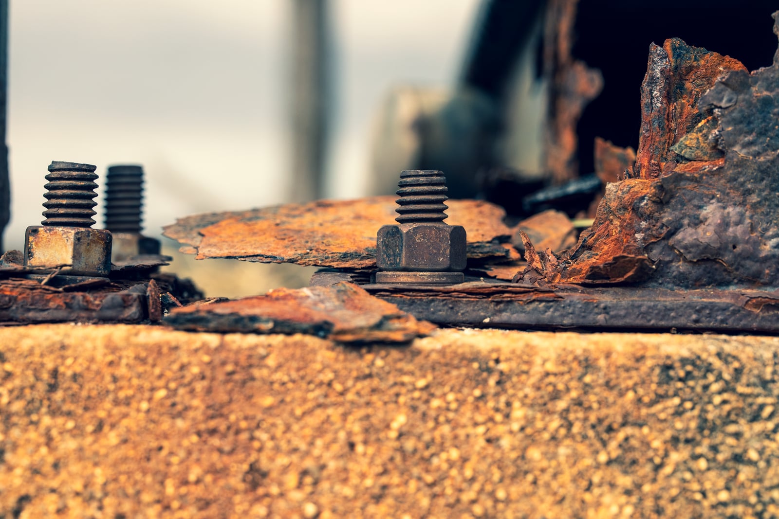 Close-up of rusted roofing fasteners showing corrosion