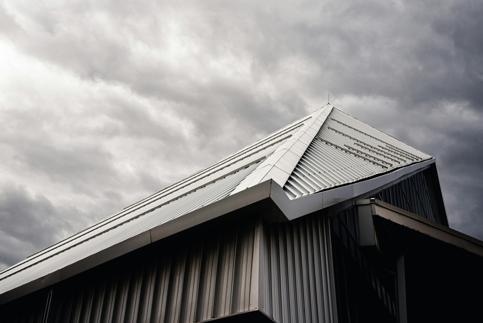 Storm damage roof repair Huntington Beach — storm clouds over a residential roof