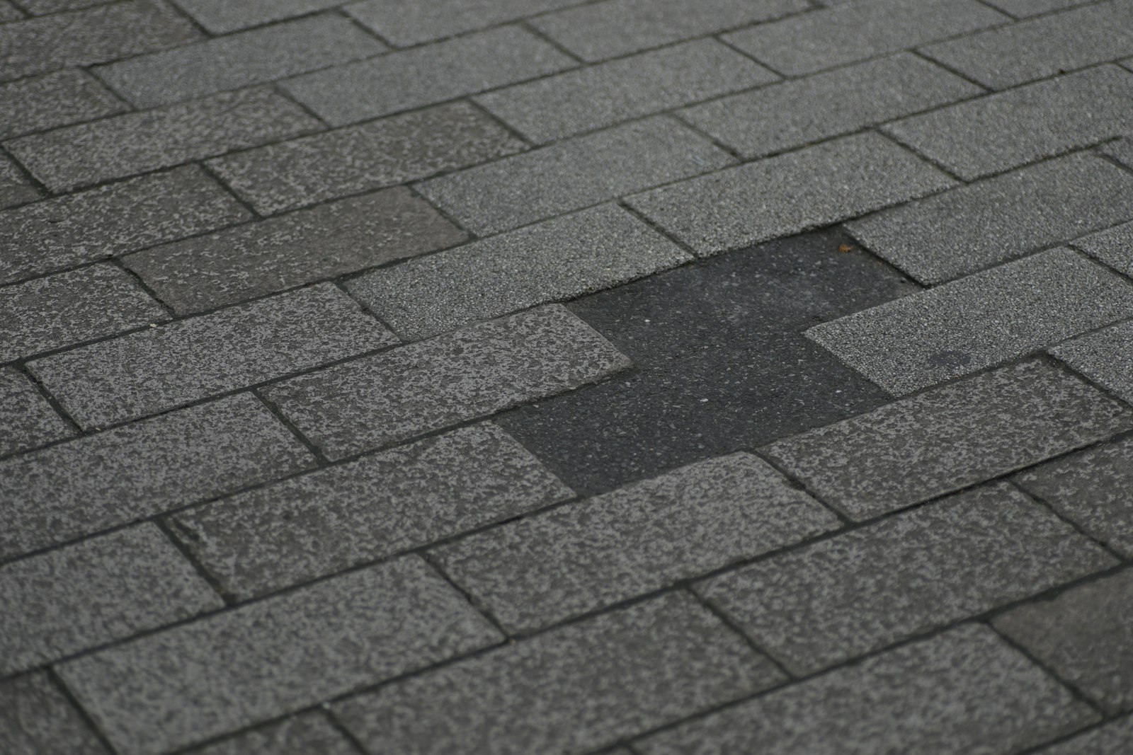 Storm damage roof repair Huntington Beach — asphalt shingle roof with missing shingles