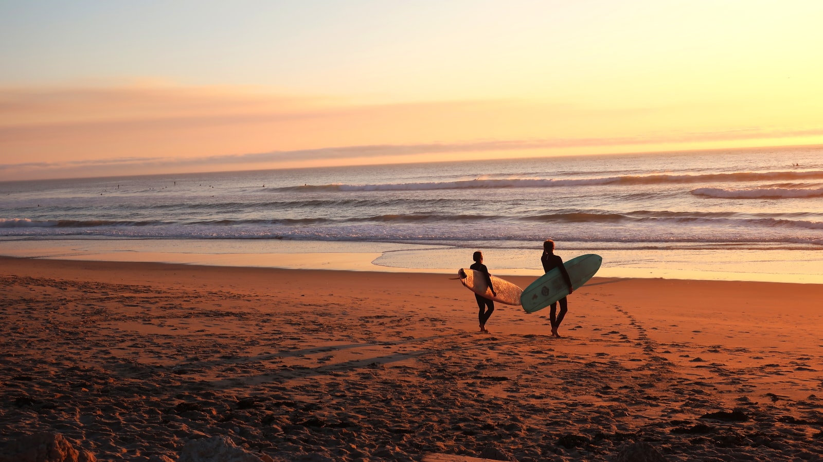 Roof repair Surf City HB — surfers on the beach in Huntington Beach