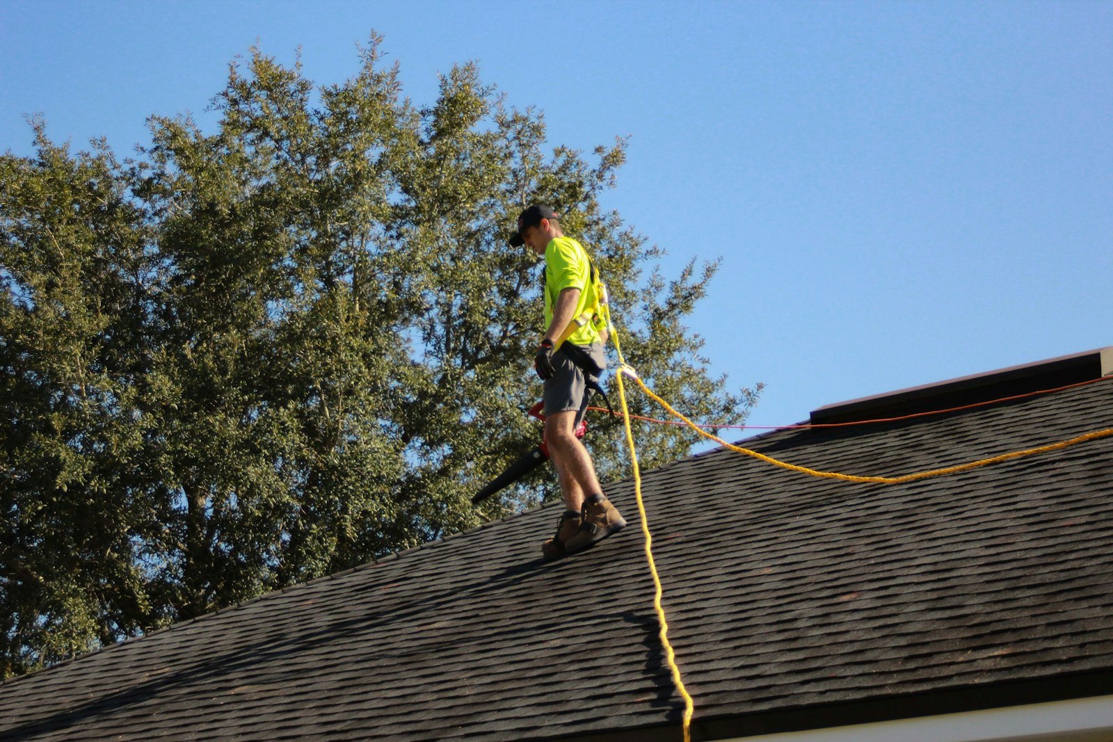 Huntington Beach roofer securing a tarp on a damaged roof