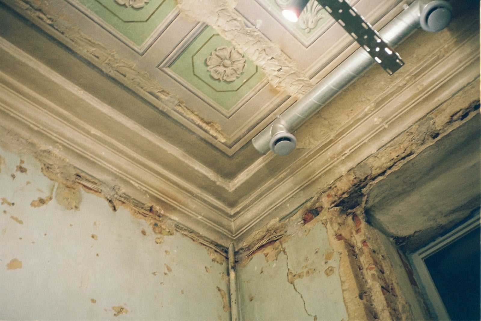 Peeling paint and water staining on a Huntington Beach ceiling from a long term roof leak