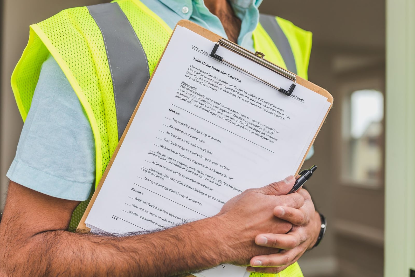 Worker holding a pen and checklist document